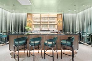 a bar in a restaurant with green chairs at La Terrasse by VIAC - Luxury Bay View Studio with Balcony 29th Floor Miami in Miami +64 photos