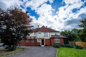 a large white and red house with a driveway at Canford house on Westbury on Trym in Bristol