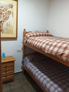 a bedroom with a bunk bed with a giraffe picture on the wall at Sierra Nevada in Sierra Nevada