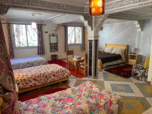 Postel nebo postele na pokoji v ubytování RIAD Camping ATLAS