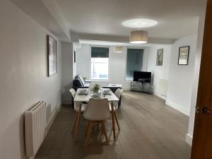 a living room with a table and chairs in a room at 1 bed spacious flat in Essex in Brentwood