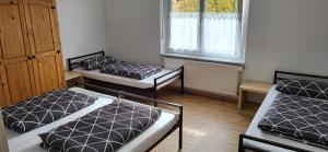 a room with three beds and a window at Ferienhaus Bauer in Zirndorf