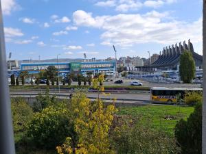 a bus driving down a highway in front of a building at Uniluxury Hotel Prishtina in Prishtinë