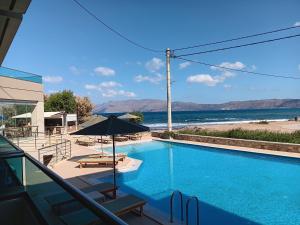 a swimming pool with a view of the ocean at Nautilus Bay Hotel in Kissamos