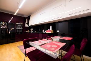 a dining room with a table and red chairs at Tirana Center Luxury Landing in Tirana