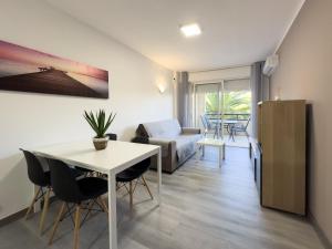 a living room with a table and a couch at Bga rentals Punta Prima in La Pineda