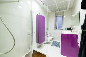 a bathroom with a purple shower and a sink at Tirana Center Luxury Landing in Tirana +30 photos