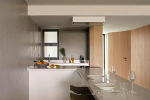 a kitchen with a counter with wine glasses at W Algarve in Albufeira