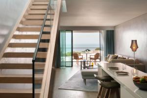 a staircase in a living room with a view of the ocean at W Algarve in Albufeira