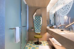 a bathroom with two sinks and a stool in it at W Algarve in Albufeira
