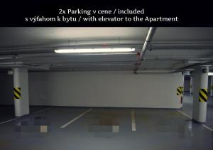 an empty parking garage with a white wall at E1 Luxury OldTown Apt - 2x Parking, Foodstore, PCscreen, Netflix, Unlimited Music, Crib, BabyChair, FastWifi, Aircon in Košice