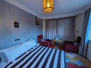 Postel nebo postele na pokoji v ubytování RIAD Camping ATLAS