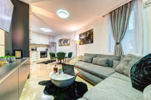 a living room with a couch and a table at Boutique Apartment Dolce Vita Free Parking in Smolyan