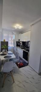 a kitchen with a table and a fire in the floor at Apartament central pe pietonala nr2 in Hunedoara