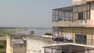 an old building with a view of a river at Banke Bihari Spiritual Stay in Vrindāvan