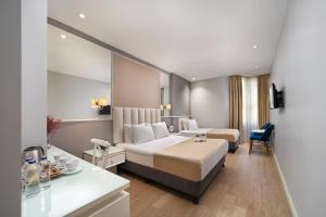 Postel nebo postele na pokoji v ubytování Ess Hotel