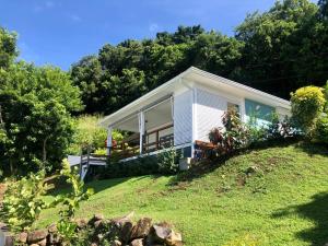 a small house on top of a hill at Villa Ti Lagon in Sainte-Luce