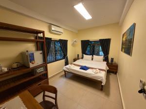 a bedroom with a bed and a television in it at Villa Blue Lagoon in Sihanoukville +47 photos