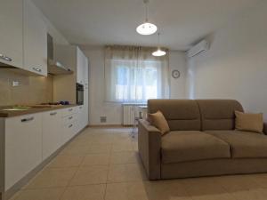 a living room with a couch and a kitchen at Felix Apartment in Pisa