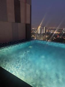 a swimming pool on top of a building at night at The Horizon Ipoh 3BR JASMINE - by Goswell in Ipoh