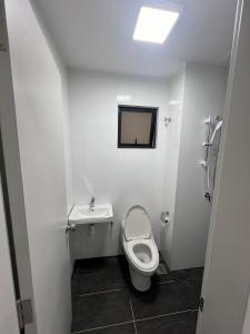 a bathroom with a toilet and a sink at The Horizon Ipoh 3BR JASMINE - by Goswell in Ipoh