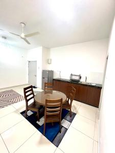 a kitchen and dining room with a table and chairs at The Horizon Ipoh 3BR JASMINE - by Goswell in Ipoh