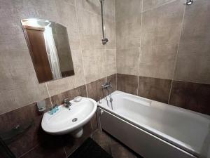 a bathroom with a sink and a bath tub and a sink at PM Services Sequoia Apartment in Borovets +40 photos