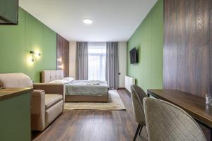 a hotel room with a bed and green walls at Garda - Breakfast included in the price Restaurant Free Parking Mountain view Kitchen in the apartment separate entrance in Bukovel