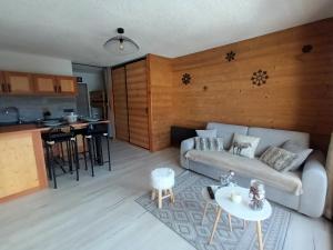 ein Wohnzimmer mit Sofa und Tisch in der Unterkunft Appartement montagne LE FLOCON in Saint-Michel-de-Chaillol