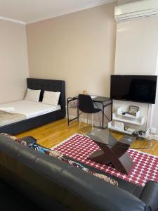 a living room with a couch and a table at Studio 110 in Luanda