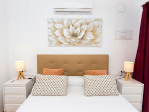 a bedroom with a large bed with two lamps at Casa Marineta III in Denia