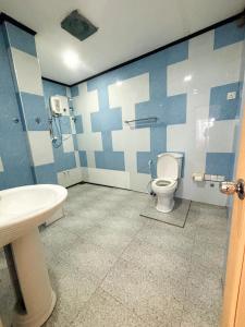 a bathroom with a toilet and a sink at Nihal Bay View in Matara +25 photos