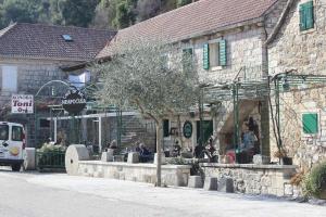 a building with people sitting outside of it at House Toncica in Dol