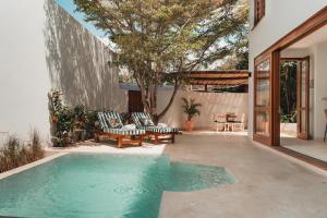 a swimming pool in the backyard of a house at Eden Escapes - Diani Beach, Kenya in Diani Beach