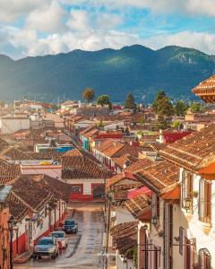 a view of a town with buildings and cars at Che San Cristobal de las Casas Hostel in San Cristóbal de Las Casas
