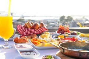 a table topped with plates of food and a glass of orange juice at HOTEL BRONTE in Istanbul