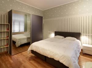 a bedroom with a large bed and a mirror at Residentie Kursaal in Ostend