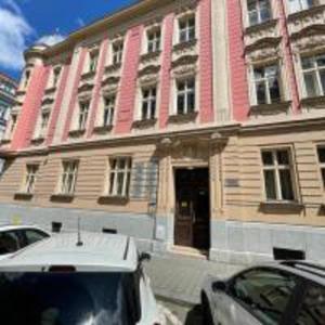 a building with a car parked in front of it at Red&Black Apartment City centr, Na Hradbách 118 in Ostrava