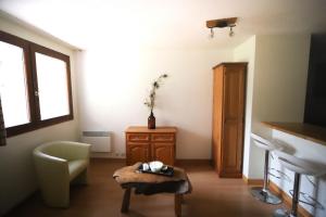 a living room with a chair and a table at Chalet Alpina résidence Val Claret in Tignes