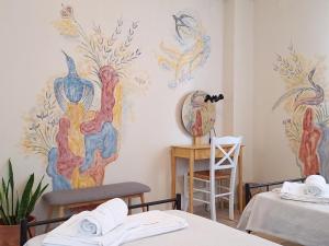 a room with a wall mural of birds on the wall at Sirens Villas in Skopelos Town