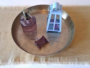 a plate with a chocolate cupcake and a candle at Sirens Villas in Skopelos Town +67 photos