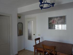 a dining room with a table and a chandelier at San Juan Playa - Free private parking in Benimagrell