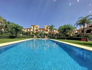 a swimming pool in front of a house at Javea Port Penthouse in Jávea