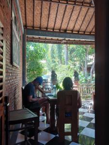 two people sitting at a table in a restaurant at Danny juljol homestay in Huu
