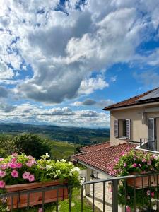 - une vue sur une maison fleurie depuis le balcon dans l'établissement Villa il Gelso, à Castagnole Lanze