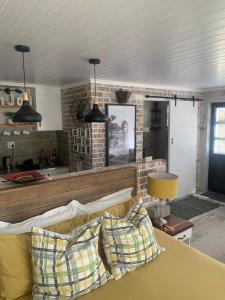 a living room with a couch with pillows on it at Just Chill Betty's Bay in Bettyʼs Bay