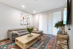 a living room with a couch and a table at 3 Lux large apartment heart of SM in Los Angeles