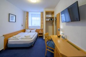 Postel nebo postele na pokoji v ubytování Hotel Pension Margit