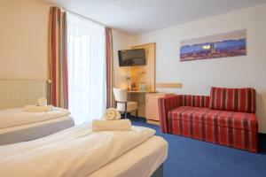 Postel nebo postele na pokoji v ubytování Hotel Pension Margit