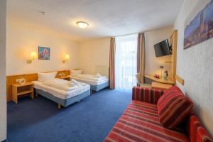 Postel nebo postele na pokoji v ubytování Hotel Pension Margit